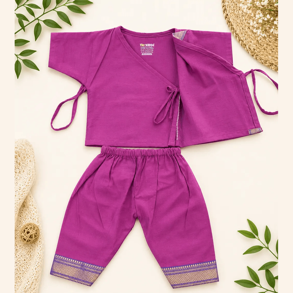 Magenta wrap-style kurta with side ties and matching pyjama, laid flat
