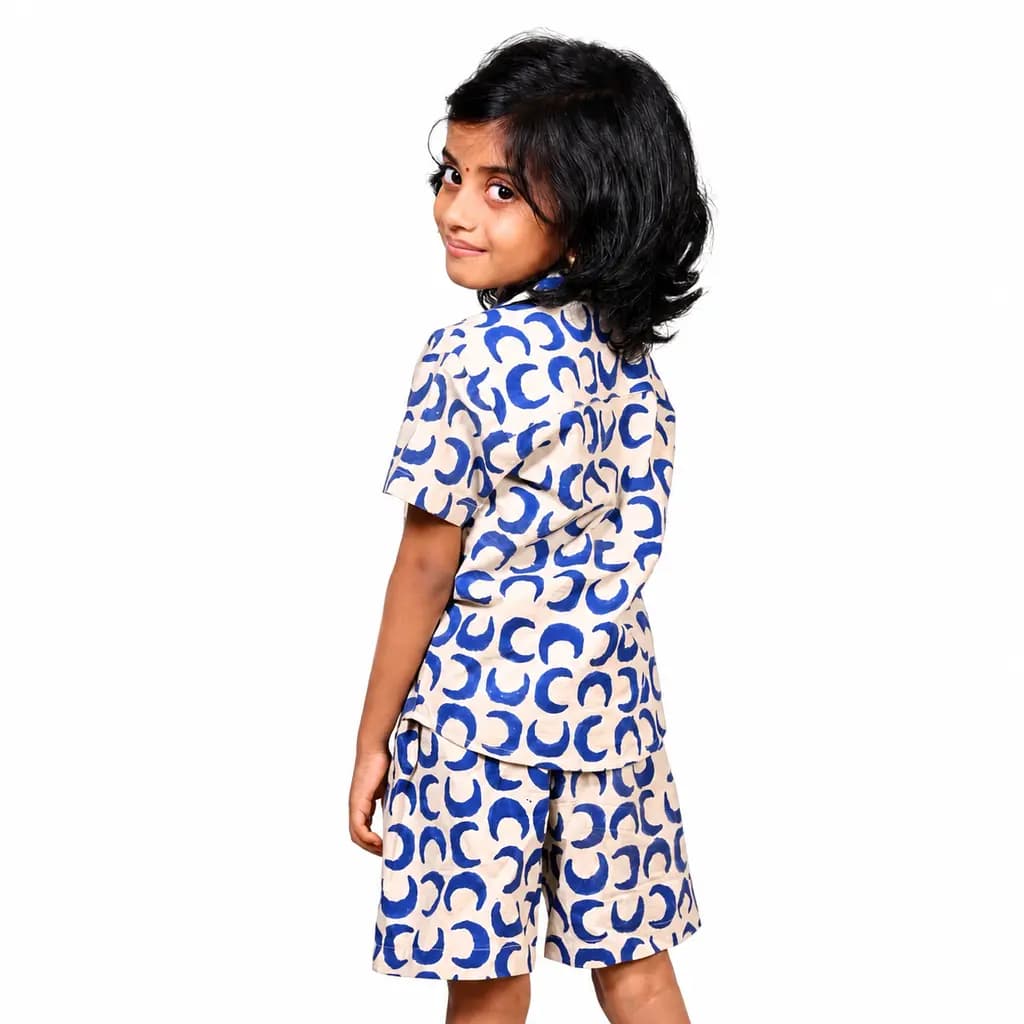 Girl wearing the Baghru block printed shirt and shorts, side view