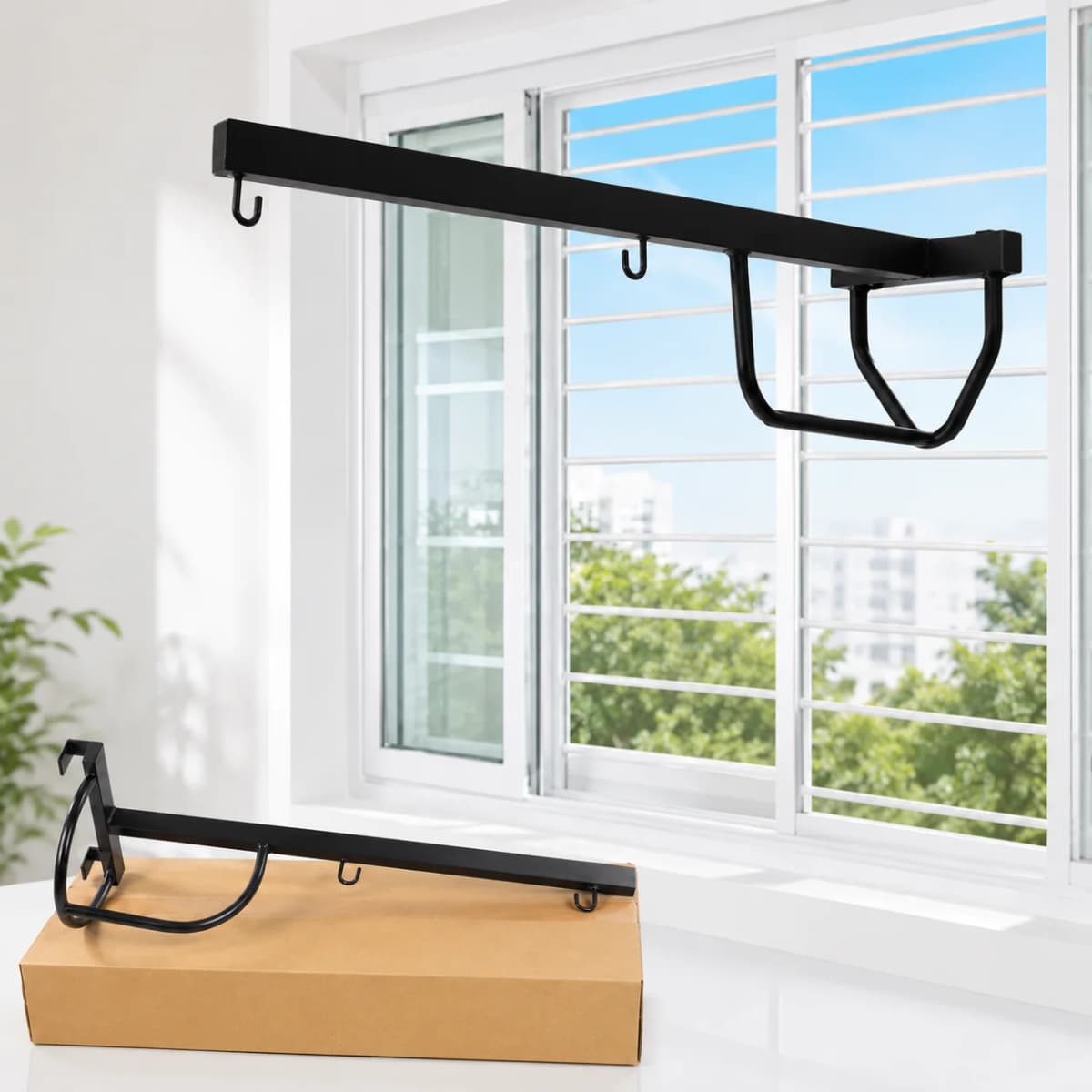 Matte black metal cradle hanger mounted across a window frame