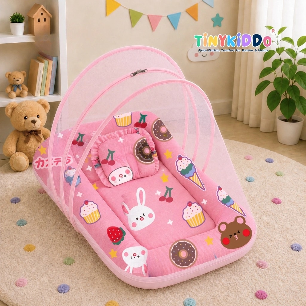 Pink baby bedding set with its pop-up mosquito net raised, on a nursery floor